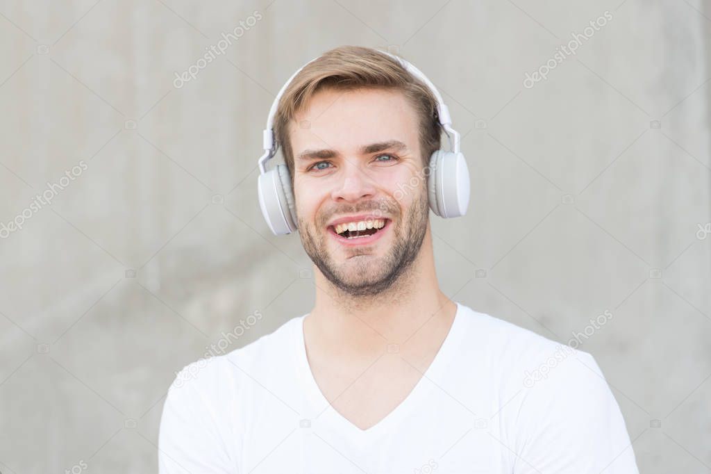 Music makes my day. Happy man listen to music grey background. Handsome guy enjoy music playing in headphones. Modern life. New technology. Fun and entertainment. Music is fun