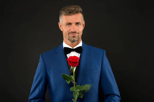 Lovely face of male. groom in tuxedo with rose. during wedding ceremony. groom in wedding jacket. bowtie is principal element for men. fashionable man with flower. groom man in suit. elegant boy — Stock Photo, Image