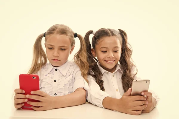 Die Zukunft ist mobil. kleine Mädchen mit Smartphones isoliert auf weiß. Kleine Kinder beim Videounterricht auf Mobiltelefonen. Vorbereitung der Studenten auf das zukünftige Leben. zukünftige Karriere mit digitalen Fähigkeiten. Zukunft — Stockfoto