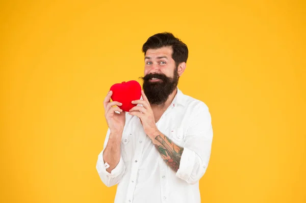 secret attraction. love and romance. being human organ donor. bearded man red heart. hipster yellow background. happy valentines day. heart poblems and disease. preventing heart attack. fall in love