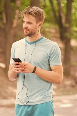Mobil bir yaşam tarzı yaşıyor. Atletik adam cep telefonu uygulaması ile faaliyetlerini takip. Spor antrenman için mobil cihaz ve fitness izlemek kullanarak. Fit adam mobil internet üzerinden fitbit veri senkronizasyonu