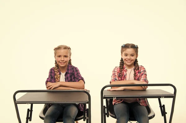 Students classmates sit desk. Back to school. Private school concept. Individual schooling. Elementary school education. Enjoy process of studying. Little girls school friends study together