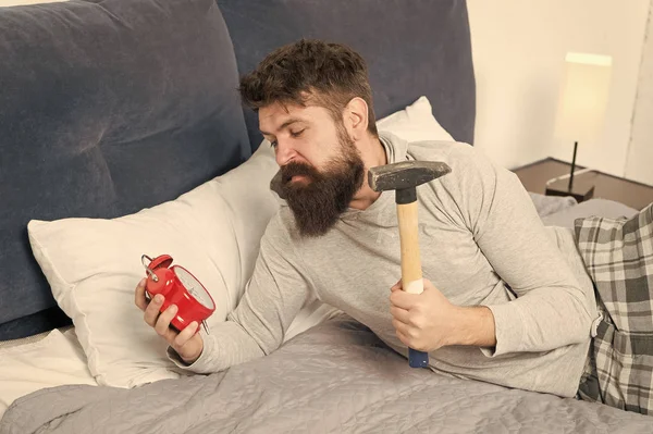 hate noise of alarm clock. Stages of sleep. Man awake unhappy with alarm clock ringing. Sleep longer. Healthy sleep concept. need more relax in bed. bearded man hipster want to sleep