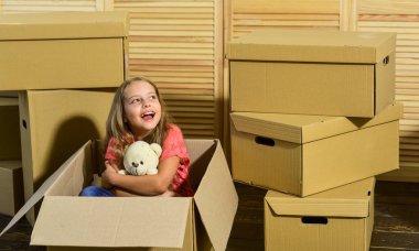 Resort apartment homes. Moving concept. new apartment. Cardboard boxes - moving to new house. purchase of new habitation. happy little girl with toy. happy child cardboard bo clipart