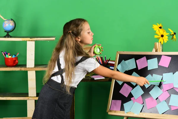 Çocuk ve okul malzemeleri yeşil duvar arka planında