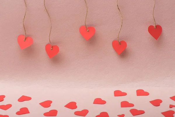 Lots of paper hearts making path on pink background