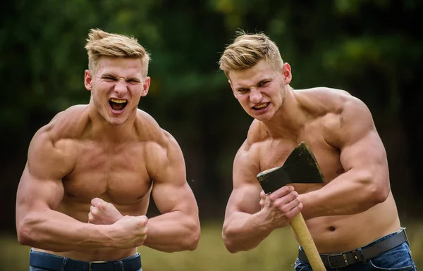 Strength and perseverance. Handsome brothers. Strong men nature background. Group muscular men with axe. Athletic twins use ax. Men with muscular torso. Genetics concept. Brotherhood friendship