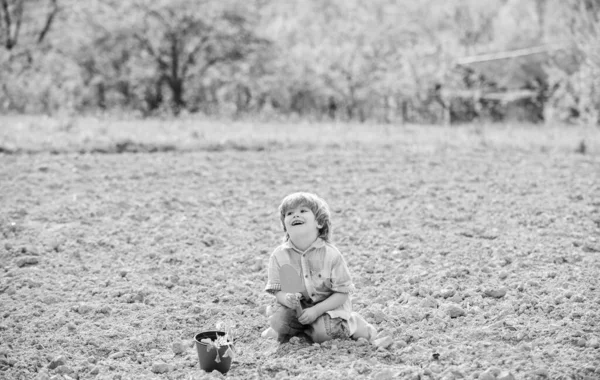 Small kid planting a flower. earth day. new life. summer farm. happy child gardener. botanic worker. Spring season. ecology and environment. farming and agriculture. Working in green environment — Stock Photo, Image