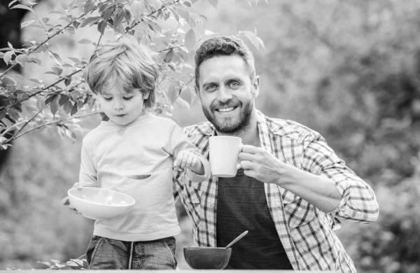 Little boy and dad eating. Nutrition kids and adults. Healthy nutrition concept. Menu for children. Nutrition habits. Family enjoy homemade meal. Healthy breakfast. Father son eat food and have fun