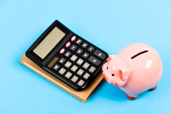 Credit debt concept. Economics and finance. Piggy bank pink pig and calculator. Business administration. Calculate profit. Finance manager wanted. Trading exchange. Trade market. Finance department