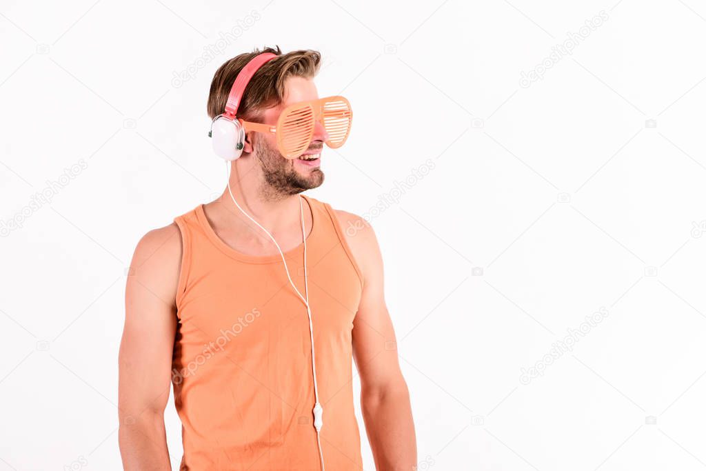 Technology and entertainment. Modern life. Handsome man with headphones and sunglasses. Party concept. Summer music chart. Guy unshaven face listening summer music. Dj boy. Popular summer track list