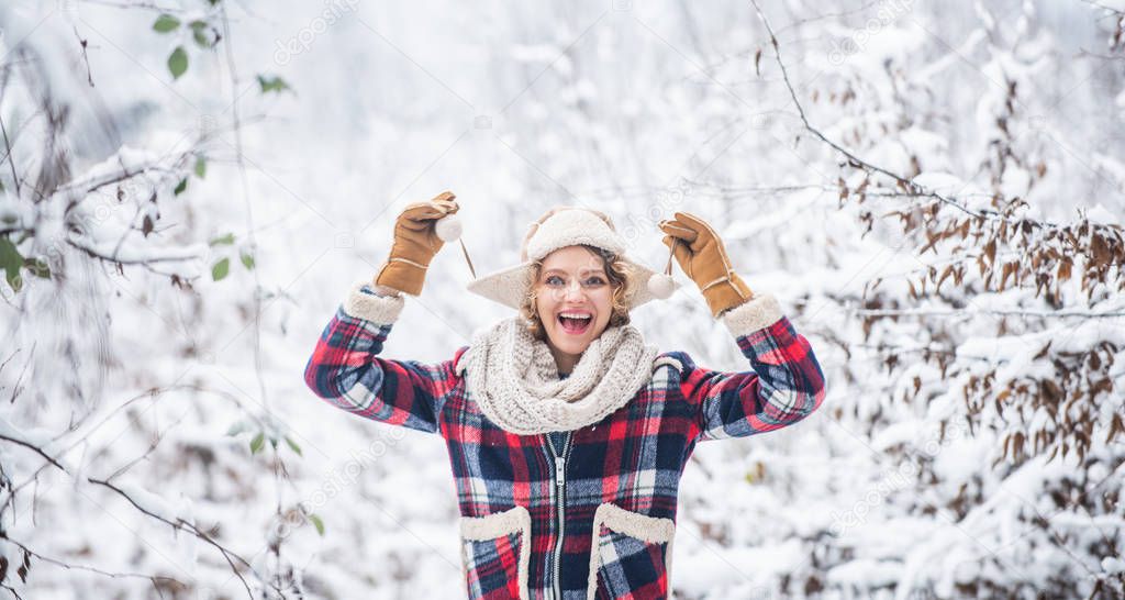 Cheerful girl outdoors. joyful and energetic woman. skiing holiday on winter day. beautiful woman in warm clothing. Enjoying nature wintertime. Portrait of excited woman in winter