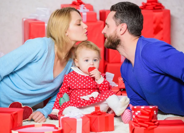 Endless love. Shopping. Boxing day. Happy family with present box. Love and trust in family. Bearded man and woman with little girl. Valentines day. Red boxes. father, mother and doughter child