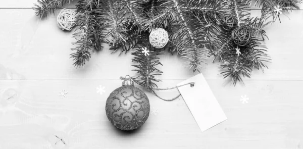 Christmas holidays concept. Decorative ball toy and gift tag copy space. Get ready for christmas. Christmas decorations wooden background top view. Everything you need to decorate christmas tree