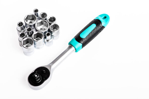 Crafts and repair. Knob for socket wrench nut ratchet close up. Ratchet tool. Ratchet wrench. Steel made no skid threaded handle without slipping. Universal socket set white background isolated