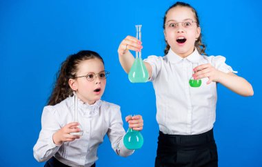 Kimya eğlencesi. Bilgi toplama günü. Renkli kimyasal sıvıları olan liseli kız. Eğitim konsepti. Güvenlik önlemleri. Küçük çocuklar ders çalışır. Kimya dersi. Kimyayla eğleniyorum. Eğitici deney.
