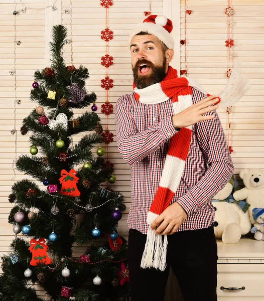 Guy in had puts red and white scarf back — Stock Photo, Image