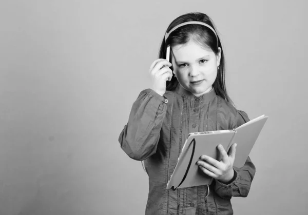 Education in reading. Cute little girl learn reading and writing in exercise book. Adorable small child holding open book for home reading. Developing reading literacy, copy space — Stock Photo, Image