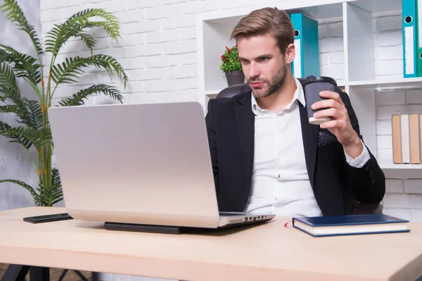 Handsome man in business office. Inspired with cup of fresh coffee. Starting own business. Ceo head office concept. Business development. Businessman drinking coffee. Confident man use laptop — Stock Photo, Image