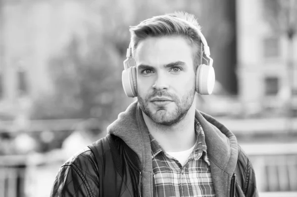 While walk. Online education courses. Listen music. Ebook audio concept. Student study use headphones. Handsome man urban background defocused. Distance education. Remote studying. Modern education