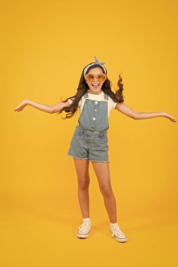 Summer fashion concept. Girl long curly hair wear sunglasses and fancy tied headscarf. Fashion trend. You can have anything you want in life if dress for it. Little fashionista. Cute kid fashion girl clipart