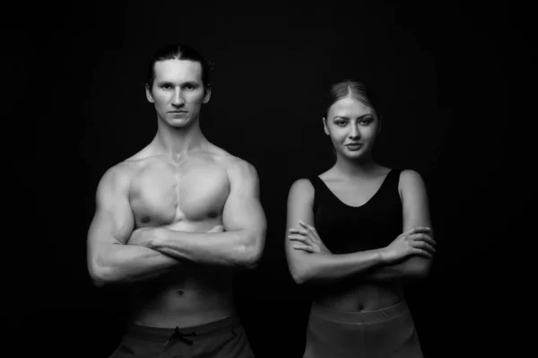 Sports for all. Sexy fit couple black background. Professional sports team. Athletic man and woman keep muscular arms crossed. Taking sports to stay in shape. Physical training and sports