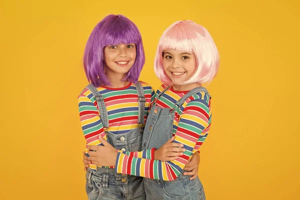 Cheerful friends in colorful wigs. Anime cosplay party concept. Anime fan. Animation style characterized colorful graphics vibrant characters fantastical themes. Anime convention. Happy little girls