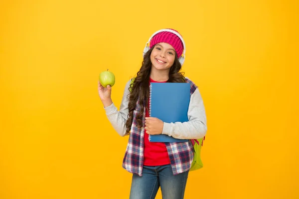 Give me break. Happy child hold apple yellow background. Little girl enjoy school break. Healthy eating and snacking. Natural snack break. Food and nutrition. Autumn holidays or break