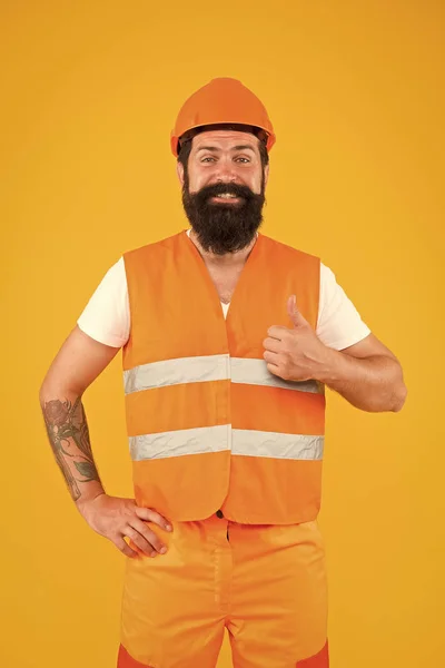 Good job. Safety apparel for construction industry. Bearded brutal hipster safety engineer. Man engineer protective uniform orange background. Engineering career concept. Architect builder engineer — Stock Photo, Image