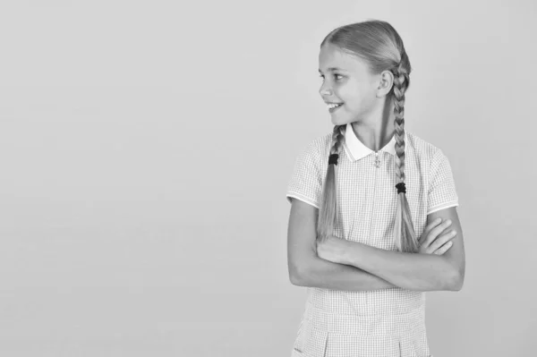 Happy childrens day. Tidy girl nice hairstyle. Positive emotions. Emotional intelligence describes ability monitor your own emotions. Smiling girl. Adorable schoolgirl yellow background. Little girl — Stock Photo, Image