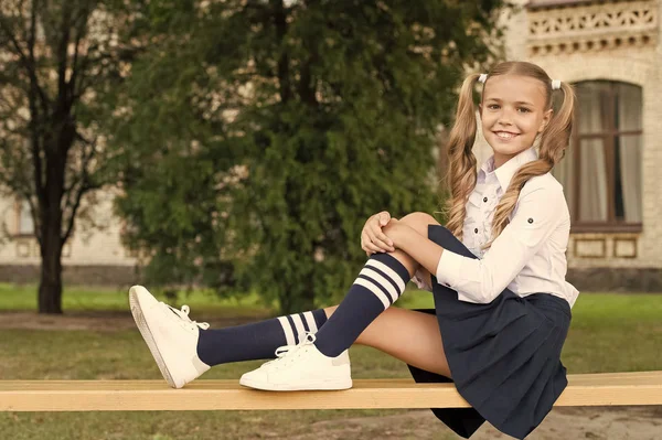 Pleasant minutes of rest. Relaxing in school yard. Perfect schoolgirl relaxing between classes. Life balance. Student adorable child in formal uniform relaxing outdoors. Time to relax and have fun — Stock Photo, Image
