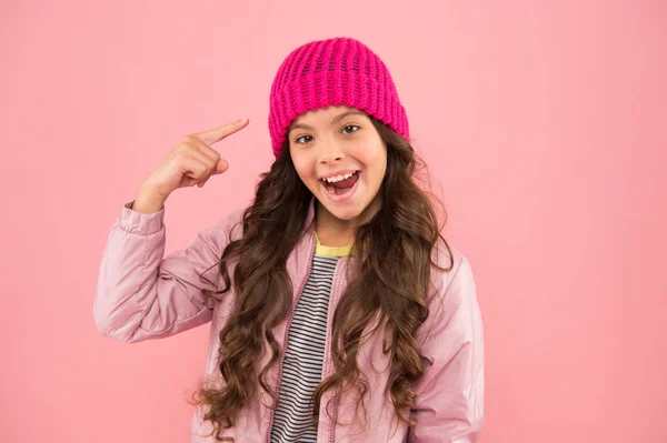 Winter fashion. how to dress warm in winter. My Favorite Clothing Item. ready for cold winter. cold climate weather. happy girl pink background. kid puffer jacket and knitted hat. winter shopping