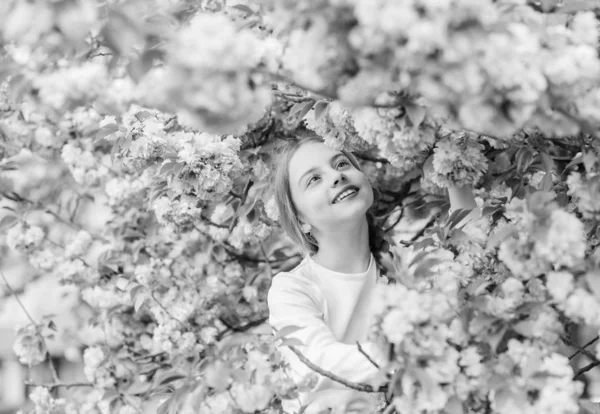 Little girl enjoy spring. Kid enjoying pink cherry blossom. Tender bloom. Pink is the most girlish color. Bright and vibrant. Pink is my favorite. Kid on pink flowers of sakura tree background — Stock Photo, Image