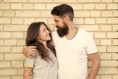 Aşık sıradan bir çift. Erkek arkadaş ve kız arkadaşı romantik tarih. Adam sakallı ve kız arkadaşlar. Aşk romantik tarih Çift açık havada tuğla duvar arka plan huddle. Şehirli gençler. Gündelik toplantı