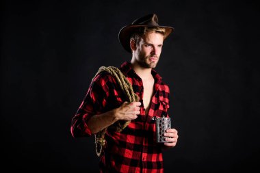 Şerif kavramı. Alkol içen vahşi bir kovboy. Batı kültürü. Şapka tutan ip ve matara giyen adam. Amerikan kovboyunun kementi. Yakışıklı, traşsız, siyah bir kovboy. Batı yaşamı