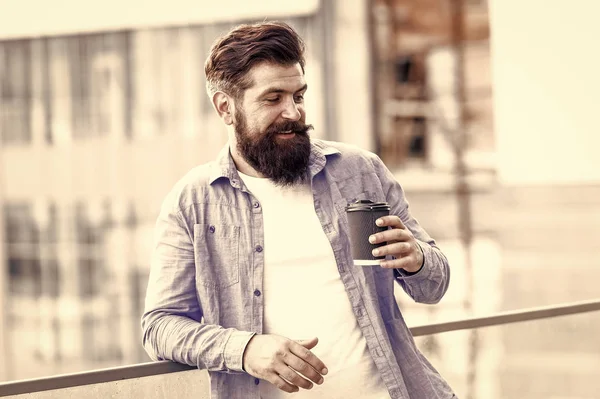 Morgonen behöver koffein. Skäggig man dricker varmt koffein dricka utomhus. Hipster hålla kopp med koffein energidryck. Kaffe ökar min energinivå, vintage filter — Stockfoto