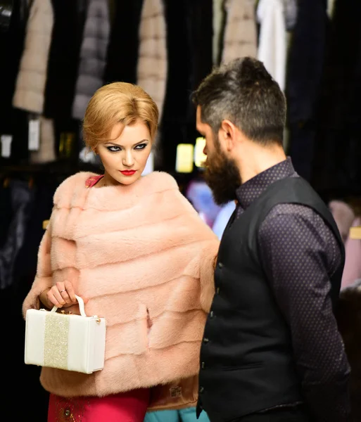 Couple in love tries expensive mink overcoats on