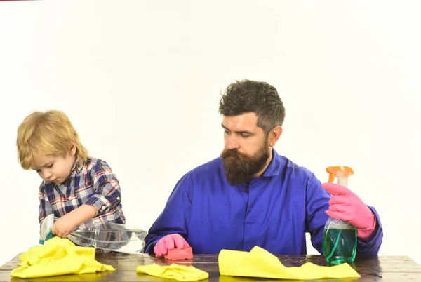 Guy with beard and mustache in rubber gloves at table.