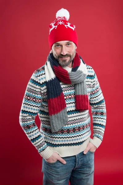 Express positivity. male fashion collection. Mature man enjoy comfort. Christmas holiday time. having new year mood. Happy bearded man red background. Knitted accessories. cold weather trends