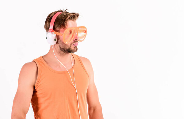 Guy unshaven face listening summer music. Dj boy. Technology and entertainment. Modern life. Handsome man with headphones and sunglasses. Party concept. Summer music chart. Popular summer track list