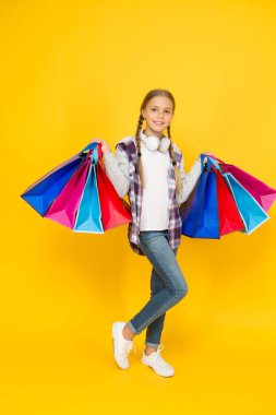 black friday. hurry up its total sale. Kids fashion. Sales and discounts. happy small girl after successful shopping. adorable child with heavy bags. Best outfit ever. holiday gifts in packages
