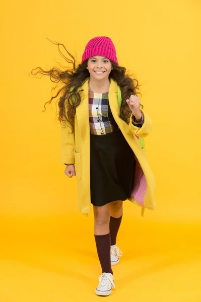 Stylish schoolgirl go forward. go to school. happy pupil kid yellow wall. back to school. desire for study. smiling child craving for education. retro and modern school. small girl enjoy autumn — Stock Photo, Image