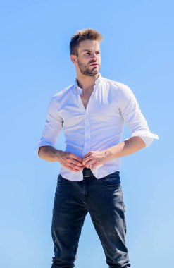 Açık havada sıcak bir gün. Sıcaklık mevsimi. Resmi moda. Resmi tarz. Çekici bir adamın gömleğini çıkarması. Cazibesine güveniyor. Sakallı adam iş stili. Yakışıklı bir manken. Seksi maço adam.