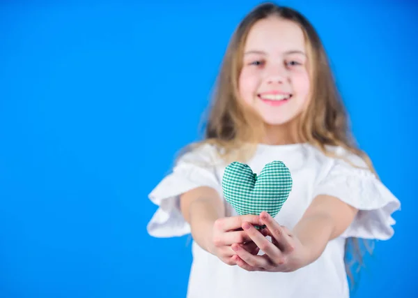 Love concept. Girl cute child show heart toy. Heart symbol of love. Romantic feelings. Kid adorable girl happy face play heart blue background. Celebrate valentines day. Love heart holiday decor — Stock Photo, Image