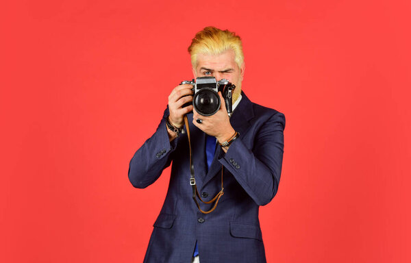 Connoisseur of vintage values. Classy and old school. Content creator. Man bearded hipster photographer. Photographer hold retro camera. Manual settings. Photographer with blond beard and mustache
