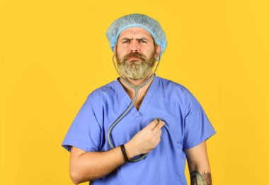 Mavi ceketli doktor. Poliklinik ve hastane. Sakallı doktor fonendoskop kullanır. Kalbinin atışını dinliyordum. Patojen zatürreeye yol açar. Kalp krizi. Çin 'den virüs enfeksiyonu