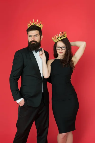 Fame and popularity. Famous couple. Proud of their love. Perfect match. Elite society. Being recognised and proud. Proud couple. Woman and bearded man wear crowns. Selfish egoist. Superiority complex