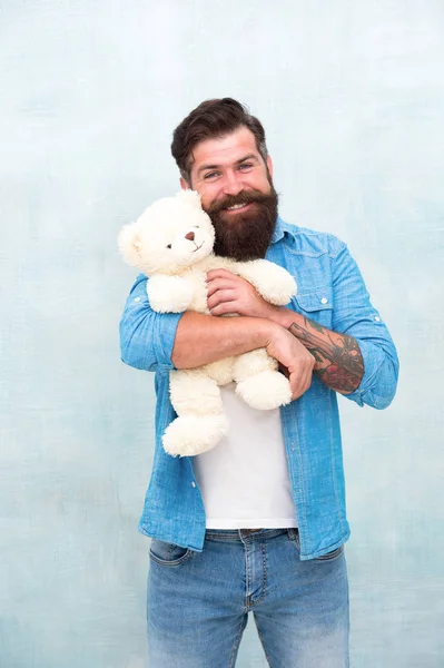 How to take care of someone. Toys shop concept. Happy birthday. Handsome hipster hold lovely bear toy. Valentines day. Present for your partner. Man with beard happy face carry gift toy. Playful mood — Stock Photo, Image