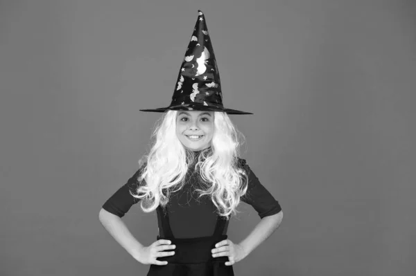 Real witch in disguise. Little child in witch costume. Halloween party. Small girl in black witch hat. Autumn holiday. Join celebration. Magical spell. Small witch with white hair. Wizard or magician