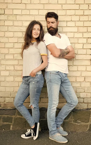 Urban youth on date. Casual meeting. Man bearded and girl friends. Couple in love romantic date huddle outdoors brick wall background. Casual couple in love. Boyfriend and girlfriend romantic date